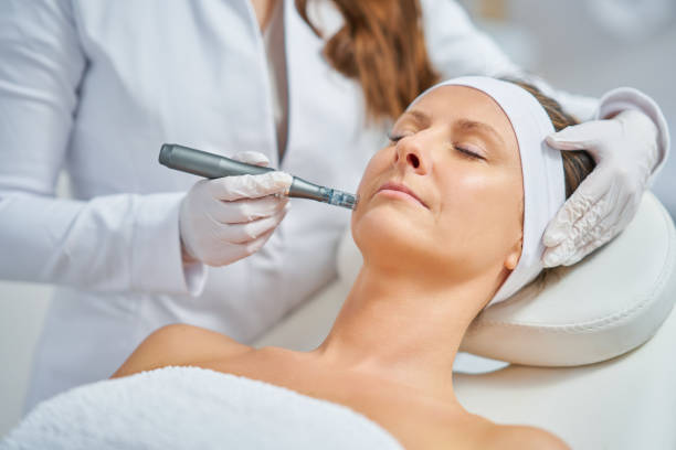 Woman receiving a microdermabrasion treatment at a spa.